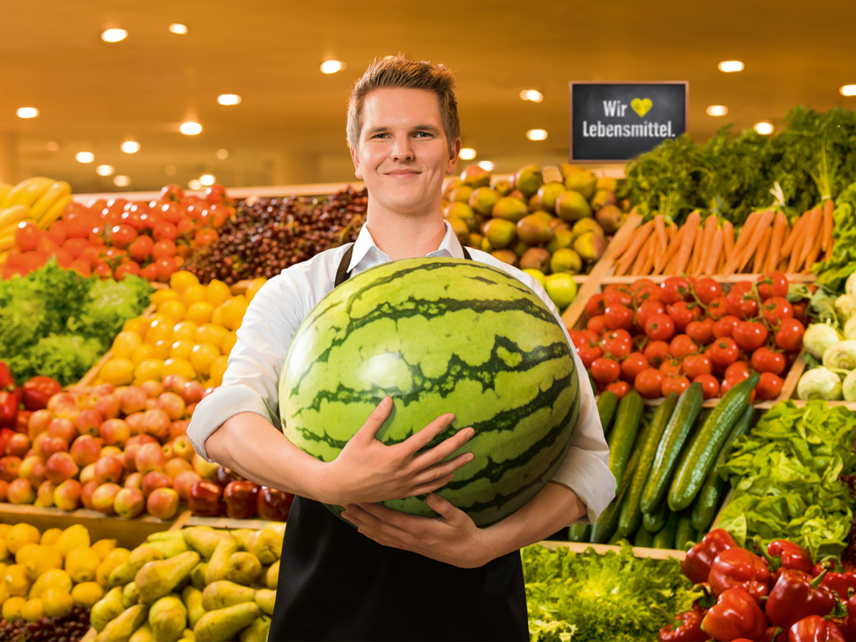 Marktmitarbeter O&G, der eine Melone trägt