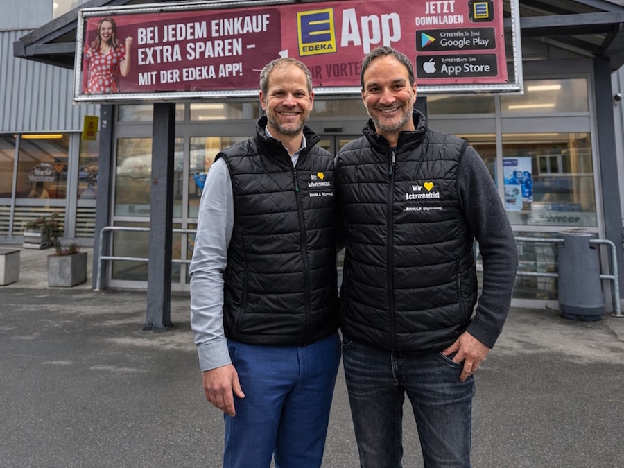 Zwei männliche Personen vor EDEKA-Markt